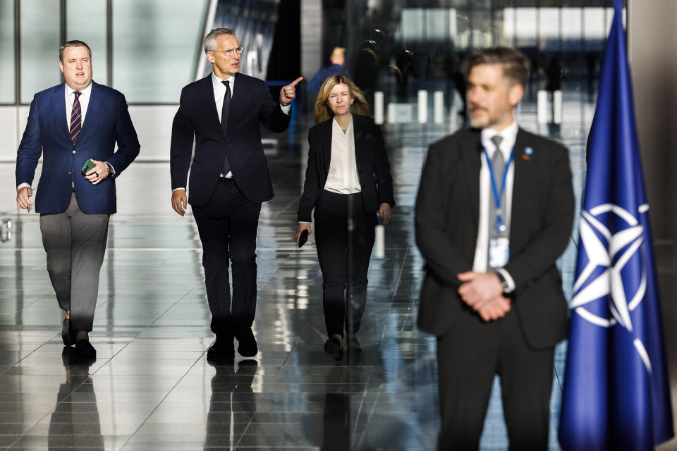 NATO Secretary General Jens Stoltenberg, second left, arrives to talk to journalists ahead of a meeting of NATO foreign ministers at NATO headquarters in Brussels, Tuesday, Nov. 28, 2023. NATO foreign ministers on Tuesday begin a two-day meeting in which the alliance will reaffirm its support for Ukraine's defense against Russia's invasion, explore ways of easing tensions between Kosovo and Serbia and look at preparations for NATO's 75th anniversary next year. (AP Photo/Geert Vanden Wijngaert)