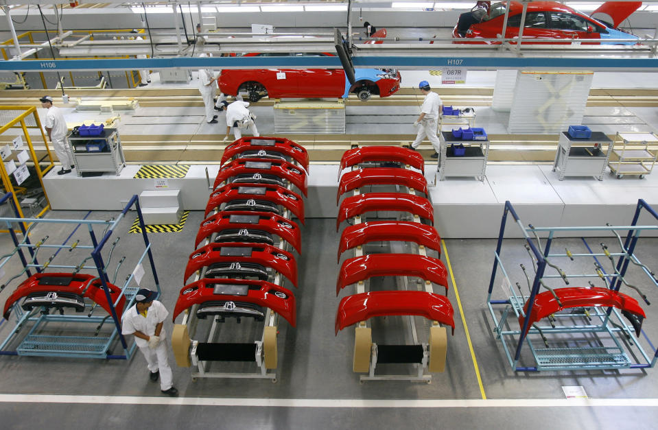 In this photo taken Tuesday July 10, 2012, Chinese workers assemble cars at a plant of Dongfeng Honda, a joint venture between China's Dongfeng Motor and Japan's Honda Motor in Wuhan in central China's Hubei province. Auto sales in China rose 9 percent in June despite a slowing economy as buyers rushed to beat possible efforts to curb traffic jams by limiting registrations, data showed Wednesday, July 11, 2012. (AP Photo) CHINA OUT