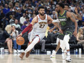 Denver Nuggets guard Jamal Murray, left, drives against Minnesota Timberwolves guard Mike Conley during the second half of Game 5 of an NBA basketball first-round playoff series Tuesday, April 25, 2023, in Denver. (AP Photo/David Zalubowski)