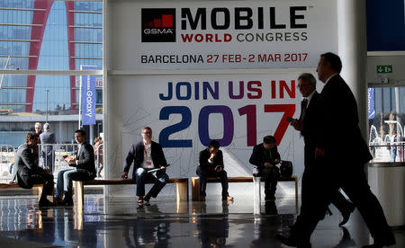 FILE PHOTO: People are seen near the main entrance during the Mobile World Congress in Barcelona, Spain February 25, 2016. REUTERS/Albert Gea/File Photo