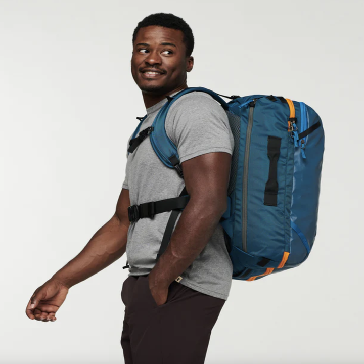 model wearing blue backpack with chest straps