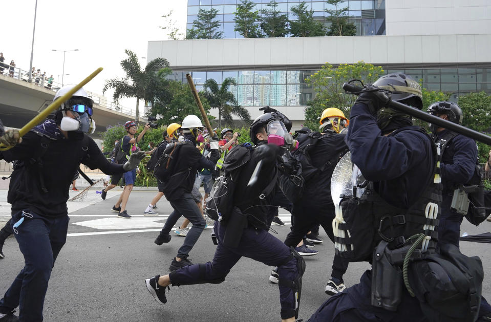 Police and demonstrators clash during a protest in Hong Kong, Saturday, Aug. 24, 2019. Chinese police said Saturday they released an employee at the British Consulate in Hong Kong as the city's pro-democracy protesters took to the streets again, this time to call for the removal of "smart lampposts" that raised fears of stepped-up surveillance. (AP Photo/Vincent Yu)