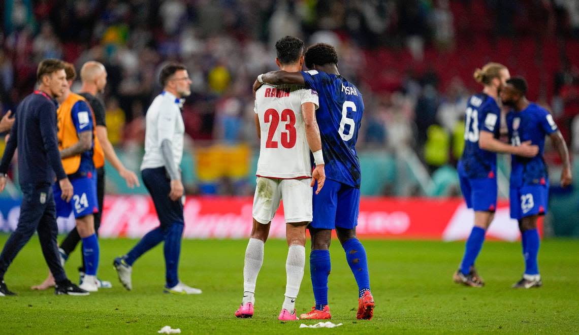 Yunus Musah of the United States, right, comforts Iran’s Ramin Rezaeian at the end of the World Cup group B soccer match between Iran and the United States at the Al Thumama Stadium in Doha, Qatar, Wednesday, Nov. 30, 2022.