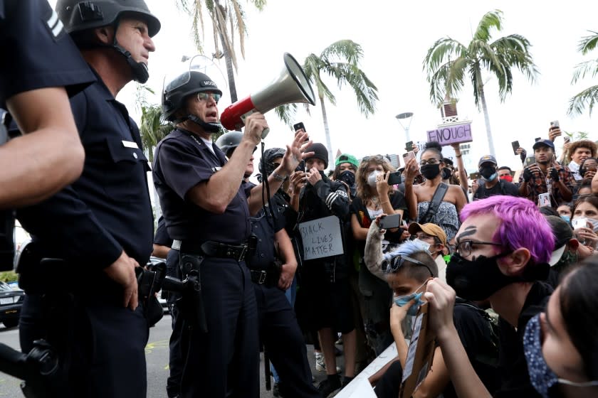 LOS ANGELES, CA -- MAY 30: Michel Moore, second from left, Chief of Police for the Los Angeles Police Department, lets protestors who are demonstrating that the area is closed at W 3rd St and S Fairfax Ave. in the Fairfax District on Saturday, May 30, 2020, in Los Angeles, CA. The protestors demonstrate in response to the death of George Floyd in Minnesota. Last night more than 500 arrests after looting and vandalism sweep downtown L.A. (Gary Coronado / Los Angeles Times)