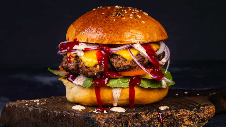 Beef burger dripping with BBQ sauce