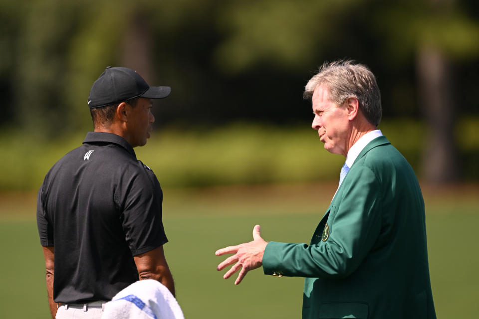 Tiger Woods speaks with Fred Ridley, Chairman of Augusta National Golf Club, in the practice area prior to the 2023 Masters Tournament. (Photo by Ross Kinnaird/Getty Images)