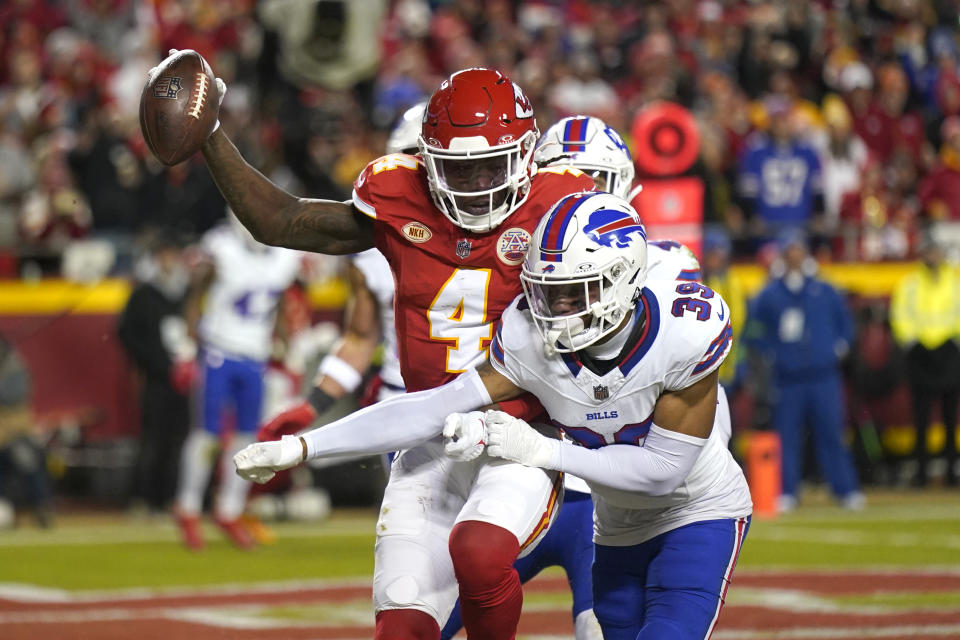 Kansas City Chiefs wide receiver Rashee Rice (4) catches a touchdown pass as Buffalo Bills cornerback Cam Lewis (39) defends during the second half of an NFL football game Sunday, Dec. 10, 2023, in Kansas City, Mo. (AP Photo/Charlie Riedel)