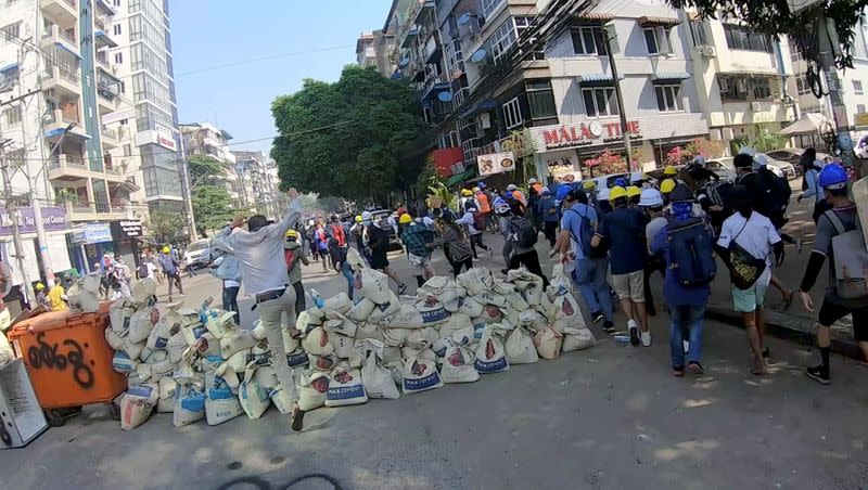 A-point-of-view from a volunteer medic running away with demonstrators from bullets, in Yangon