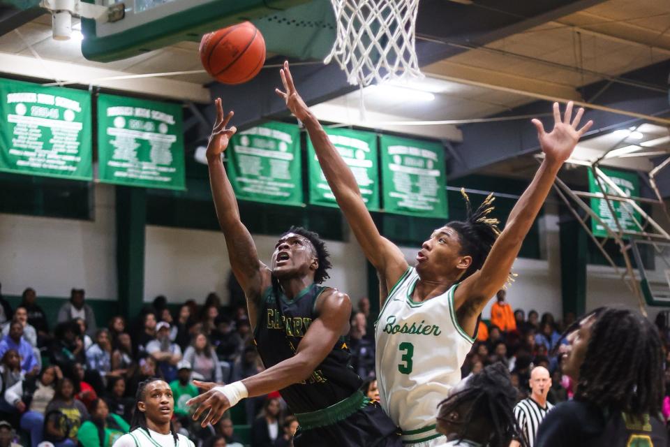 Calvary point guard Rondae Hill (left) throws up a heavily contested shot defended by Bossier forward Kerel Woods (right) at the Bossier Basketball Invitational on Saturday, January 6, 2024, in Bossier City, La.