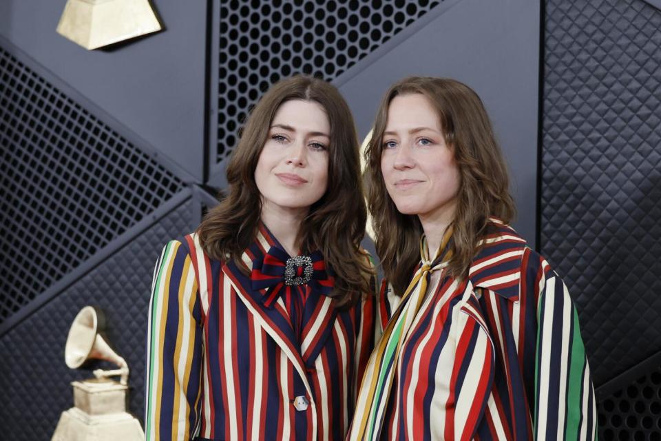 Rebecca and Megan Lovell of Larkin Poe wear striped suits