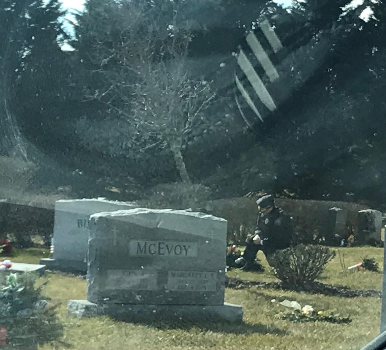 A lone man in a blue uniform kneels at the grave of Beau Biden at St. Joseph on the Brandywine church in Greenville, Delaware, on Wednesday. (Photo: Patricia Talorico/The News Journal/Imagn)