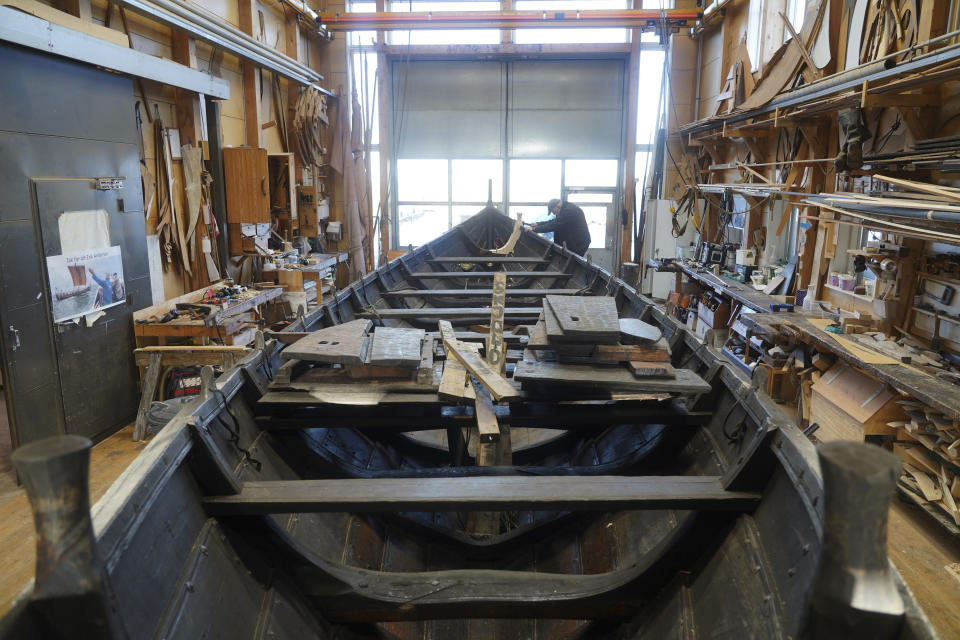 A man repairs a 10-meter wooden row boat, built in the Nordic clinker boat tradition, at the Viking Ship Museum's boatyard. Roskilde, Denmark, Monday, Jan. 17, 2022. For thousands of years, wooden sail boats, best known for having been in use during the Viking-era, allowed the peoples of northern Europe to spread trade, influence and -- in some cases war — across the seas and rivers. In December, UNESCO, the U.N.’s culture agency, added the “clinker’ boat traditions to its list of “Intangible Cultural Heritage,” the result of the first joint nomination from the whole Nordic region. (AP Photo/James Brooks)