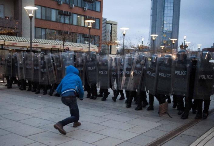 A protestor throws a rock towards riot police in Pristina, Kosovo on January 24, 2015 (AFP Photo/Armend Nimani)