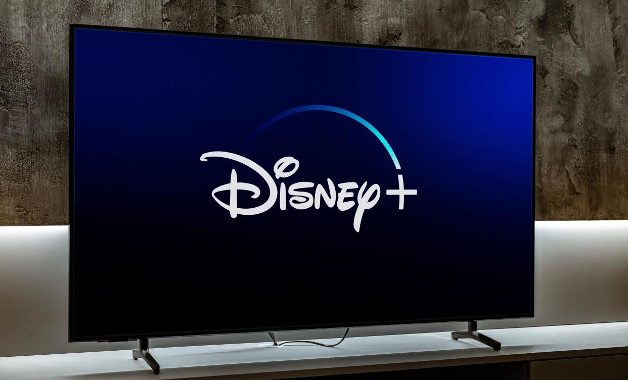 POZNAN, POL - DEC 19, 2023: Flat-screen TV set displaying logo of Disney+, an American subscription video on-demand streaming service owned and operat