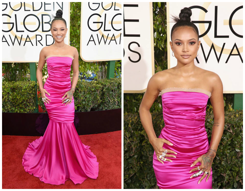 <p><b>Grade: B-</b><br>Tran’s bold pink gown exudes energy — the ruffles we could do without. </p>