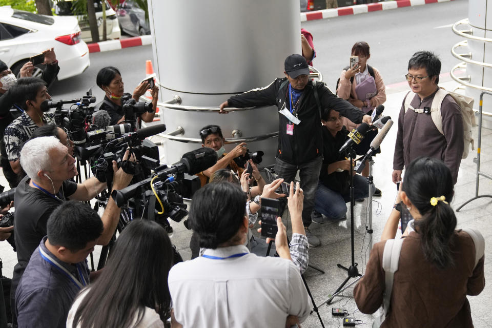 Arnon Nampa, right, talks to the media on the arrival at the Criminal court to hear his first verdict in his trial, Tuesday, Sept. 26, 2023. The prominent Thai human rights lawyer was convicted on Tuesday of insulting the monarchy and sentenced to four years in prison, the first conviction under a controversial law guarding the royal institution since a civilian government took office after years of military-backed rule.(AP Photo/Sakchai Lalit)