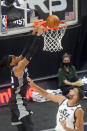 Sacramento Kings center Richaun Holmes, left, dunks as Utah Jazz center Rudy Gobert (27) looks on in the first half during an NBA basketball game Saturday, April 10, 2021, in Salt Lake City. (AP Photo/Rick Bowmer)