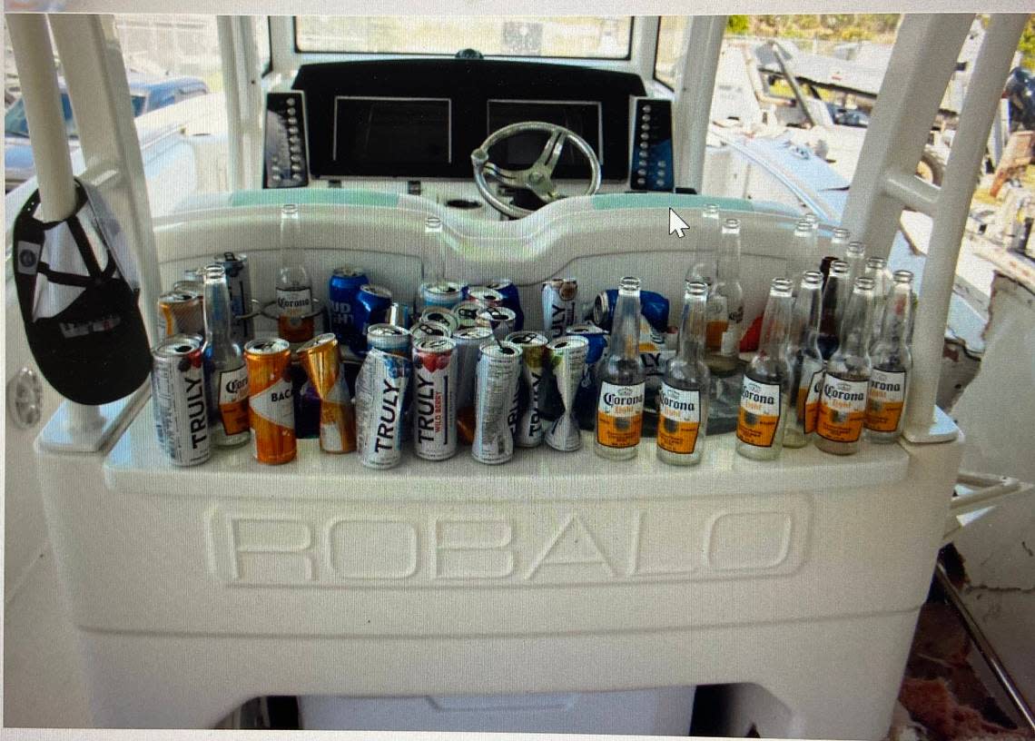 Empty beer and other alcoholic beverage bottles and cans are lined up behind the cockpit of George Pino’s 29-foot Robalo boat on Sept. 5, 2022. the day after Pino crashed into a channel marker in Biscyane Bay, leading to the death of a 17-year-old girl and brain injury to another girl on the boat.