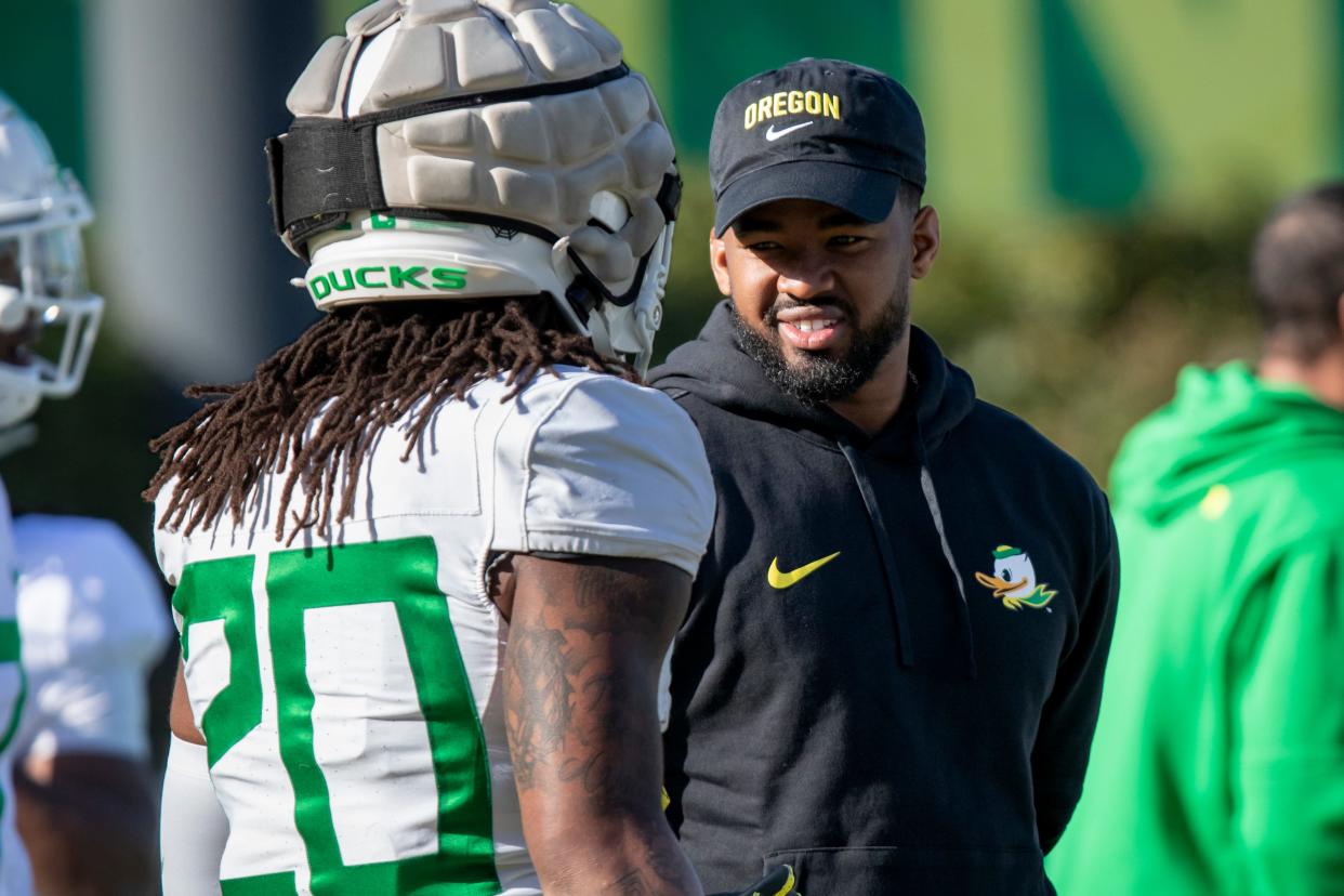 New Oregon running backs coach Ra’Shaad Samples talks with running back Jordan James during practice with the Oregon Ducks April 9 at the Hatfield-Dowlin Complex in Eugene.