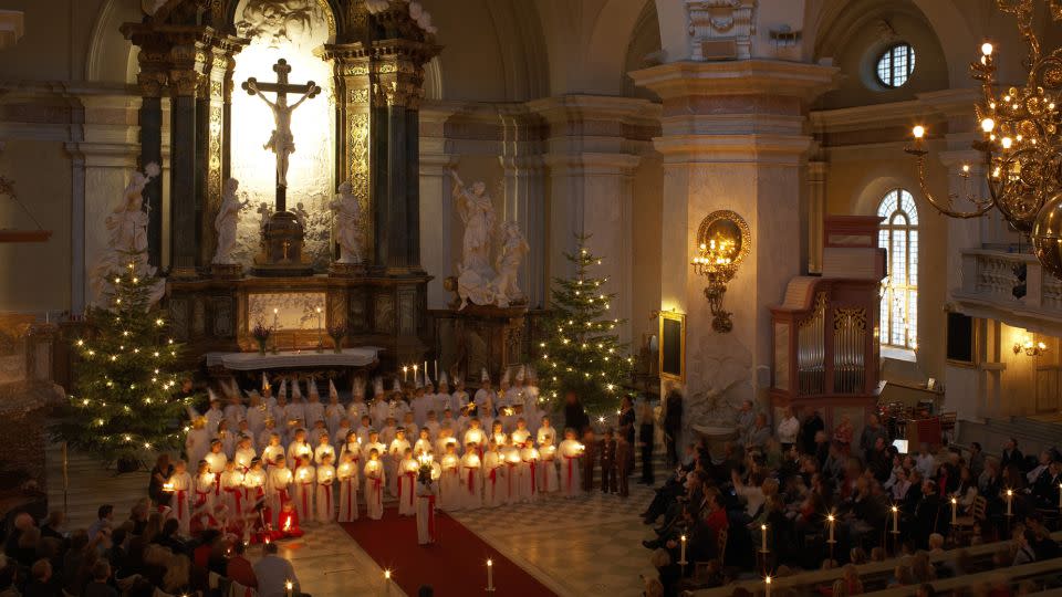 An early morning Lucia Day procession takes place in Gustaf Vasa church in Stockholm. - Ola Ericson/Visit Sweden