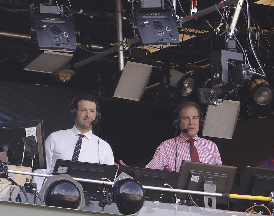FILE - In this Sept. 24, 2017, file photo, Tony Romo and Jim Nantz work in the broadcast booth before an NFL football game between the Green Bay Packers and the Cincinnati Bengals in Green Bay, Wis. Nantz and Romo were inseparable when CBS broadcast the Super Bowl two years ago. Next week, they won't see each other until they are in the broadcast booth a couple hours prior to kickoff. Keeping announcers separated until game day has been standard practice this season due to the Coronavirus pandemic. (AP Photo/Morry Gash, File)