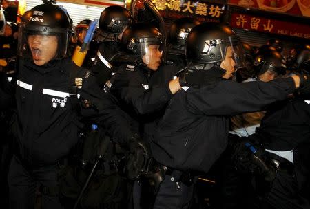 Riot police react as they charge protesters supporting illegal hawkers at Hong Kong's Mongkok shopping district, China early February 9, 2016. REUTERS/Liau Chung-ren