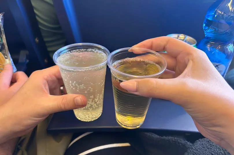 Photo shows two drinks in plastic cups on a Ryanair flight