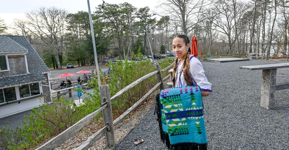 Mashpee Wampanoag Tribe member Madas Strickland stands on Friday next to Naukabout Brewing Company, formerly The Flume restuarant, in Mashpee. The restaurant was operated by her grandfather.