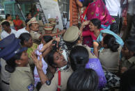 Indian police detain members of Centre of Indian Trade Unions protesting against the visit of U.S. President Donald Trump to India, in Hyderabad, India, Monday, Feb. 24, 2020. India poured on the pageantry with a joyful, colorful welcome for President Donald Trump who on Monday kicked off a whirlwind 36-hour visit that emphasizes pageantry over policy and a mega-rally to reaffirm U.S.-India ties while providing enviable overseas imagery for a president in a re-election year. (AP Photo/Mahesh Kumar A.)