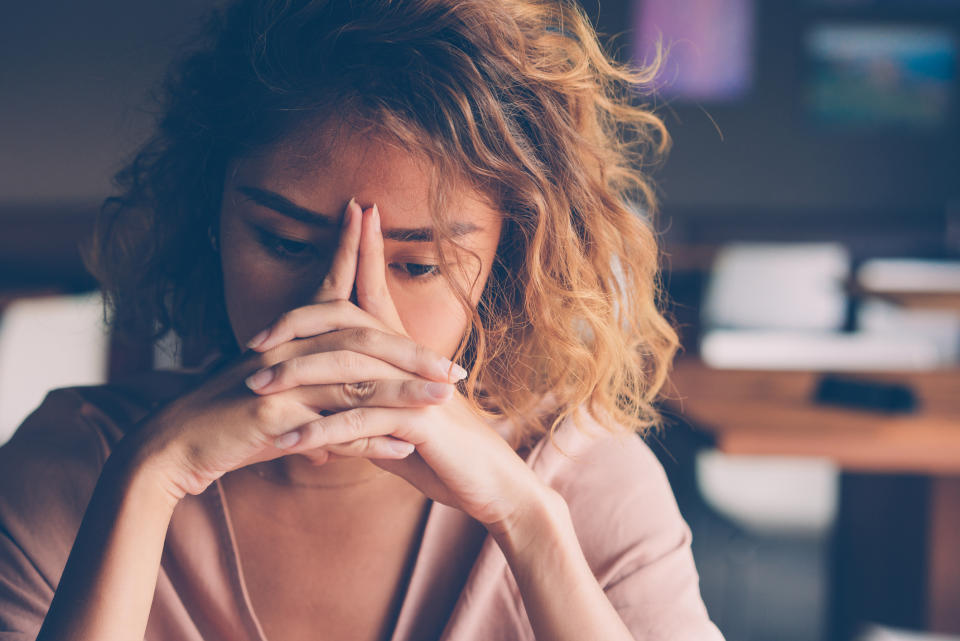 Woman dealing with feelings of overwhelm. (Getty Images)