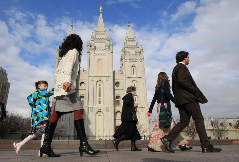 People walk pass the Salt Lake Temple on the way to the Conference Center during opening session of the two-day Mormon church conference Saturday, April 5, 2014, in Salt Lake City. More than 100,000 Latter-day Saints are expected in Salt Lake City this weekend for the church's biannual general conference. Leaders of The Church of Jesus Christ of Latter-day Saints give carefully crafted speeches aimed at providing members with guidance and inspiration in five sessions that span Saturday and Sunday. They also make announcements about church statistics, new temples or initiatives. In addition to those filling up the 21,000-seat conference center during the sessions, thousands more listen or watch around the world in 95 languages on television, radio, satellite and Internet broadcasts. (AP Photo/Rick Bowmer)