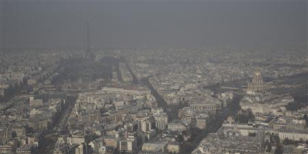 A general view shows the Eiffel tower and the Paris skyline through a small-particle haze March 13, 2014 as warm and sunny weather continues in France. Residents and visitors to Paris basking in a streak of unseasonable sunshine were also being treated with a dangerous dose of particles from car fumes that pushed air pollution to levels above other northern European capitals this week. REUTERS/Philippe Wojazer