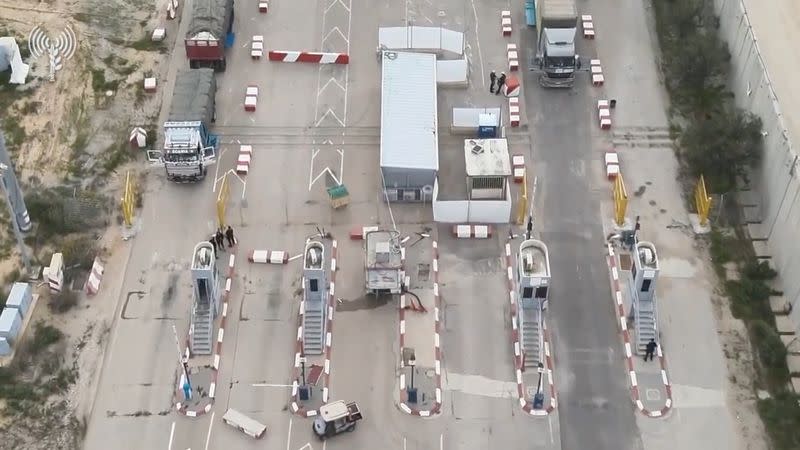 Humanitarian aid trucks wait in line to be inspected at the Kerem Shalom crossing