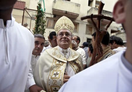 Cuba's Cardinal Jaime Ortega (C), archbishop of Havana, arrives at a church during the annual procession of Our Lady of Charity, the patron saint of Cuba, in Old Havana in this September 8, 2009 file picture. REUTERS/Enrique De La Osa/Files