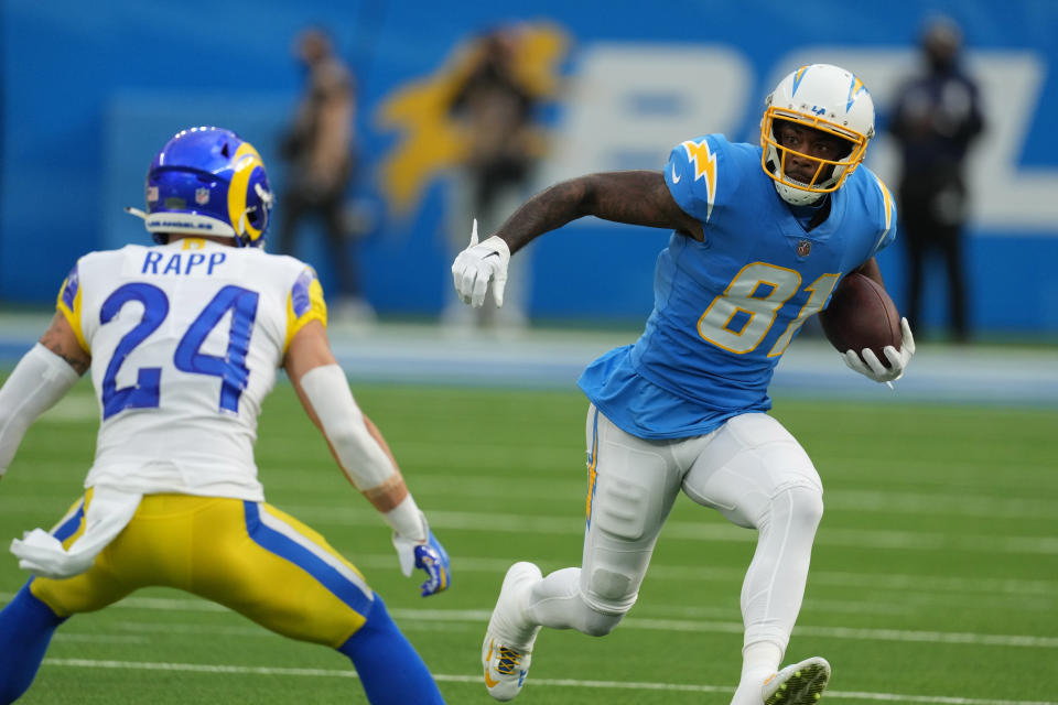 Jan 1, 2023; Inglewood, California, USA; Los Angeles Chargers wide receiver Mike Williams (81) carries the ball in the first half against Los Angeles Rams safety Taylor Rapp (24) at SoFi Stadium. Mandatory Credit: Kirby Lee-USA TODAY Sports