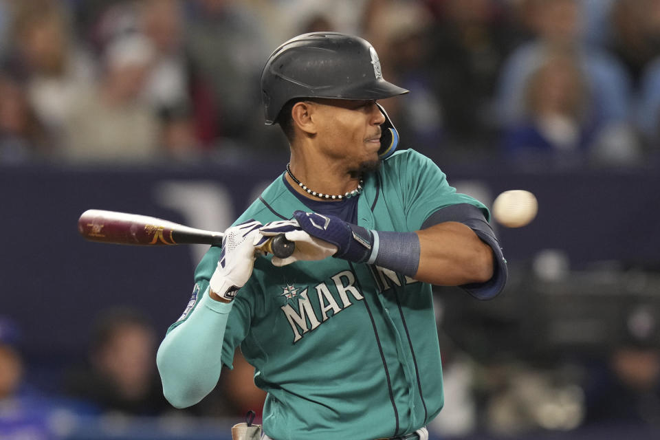 Seattle Mariners' Julio Rodriguez tries to dodge a pitch from Toronto Blue Jays' Alek Manoah during the second inning of a baseball game Friday, April 28, 2023, in Toronto. (Chris Young/The Canadian Press via AP)