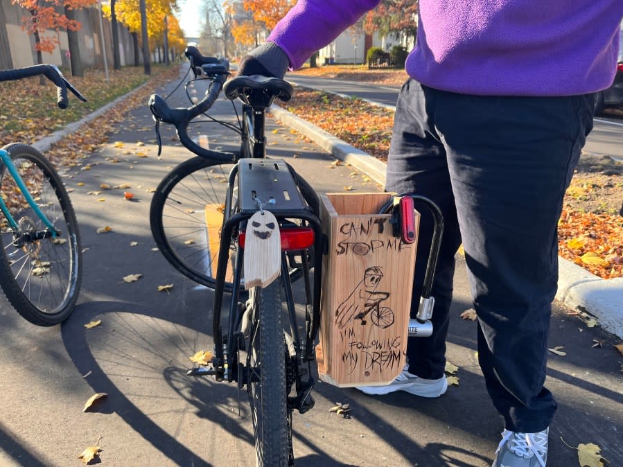 Donovan Tesin with the Greater Grand Rapids Bicycle Coalition shows his bike on the protected bike path along Turner Avenue. (Nov. 15, 2023)