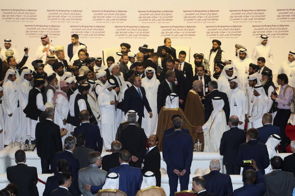 Officials leave after the agreement signing between Taliban and U.S. officials in Doha, Qatar, Saturday, Feb. 29, 2020. The United States is poised to sign a peace agreement with Taliban militants on Saturday aimed at bringing an end to 18 years of bloodshed in Afghanistan and allowing U.S. troops to return home from America's longest war. (AP Photo/Hussein Sayed)