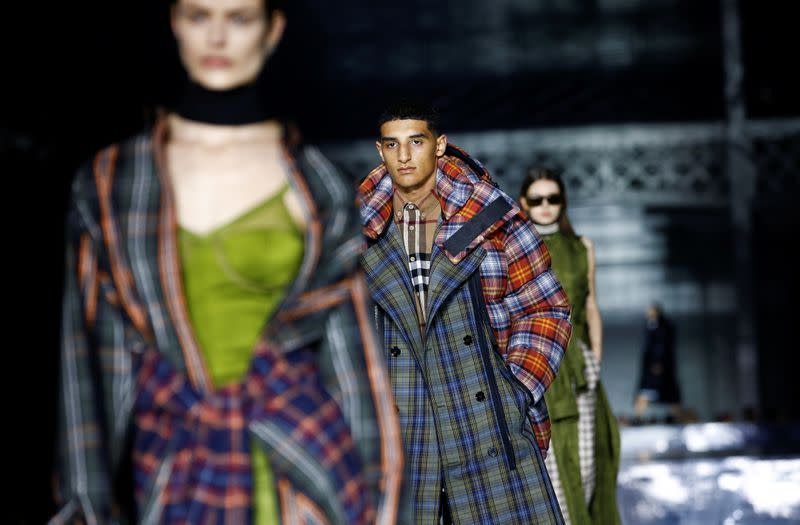 Models present creations during the Burberry catwalk show at London Fashion Week in London