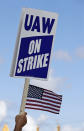 A picketer holds up a strike sign outside the the General Motors Fabrication Division, Monday, Sept. 23, 2019, in Parma, Ohio. The strike against General Motors by 49,000 United Auto Workers entered its second week Monday with progress reported in negotiations but no clear end in sight. (AP Photo/Tony Dejak)