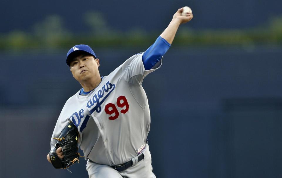 Los Angeles Dodgers starting pitcher Hyun-Jin Ryu works against the San Diego Padres in the first inning of the opening game of Major League baseball in the United States, Sunday, March 30, 2014, in San Diego. (AP Photo/Lenny Ignelzi)