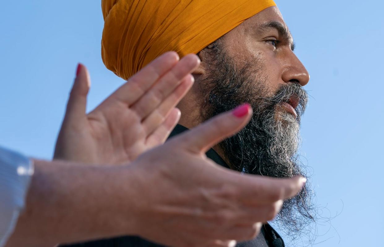 A woman applauds as New Democratic Party Leader Jagmeet Singh does his morning announcement during an election campaign stop in Hamilton, Ont., Monday, Sept. 6, 2021.   (THE CANADIAN PRESS/Jonathan Hayward - image credit)