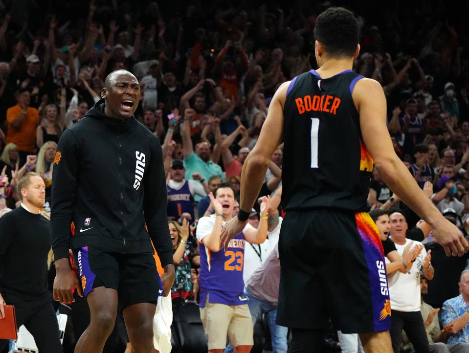 May 10, 2022; Phoenix, Arizona; USA; Suns center Bismack Biyombo greets teammate Devin Booker (1) after a dunk against the Mavericks during game 5 of the second round of the Western Conference Playoffs.