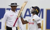 Sri Lankan batsman Pathum Nissanka looks skywards as he celebrates scoring a half century against West Indies during the day one of the second test cricket match in Galle, Sri Lanka, Monday, Nov. 29, 2021. (AP Photo/Eranga Jayawardena)