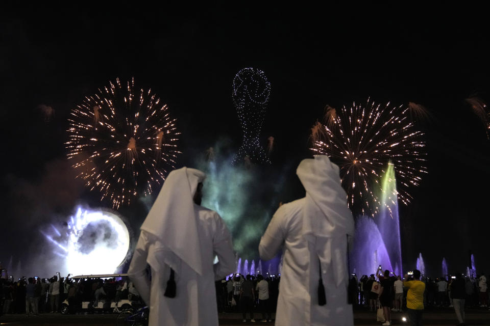 People watch a fireworks display as part of the World Cup soccer tournament FIFA fan festival on Doha corniche, in Doha, Qatar, Wednesday, Nov. 30, 2022. (AP Photo/Lee Jin-man)