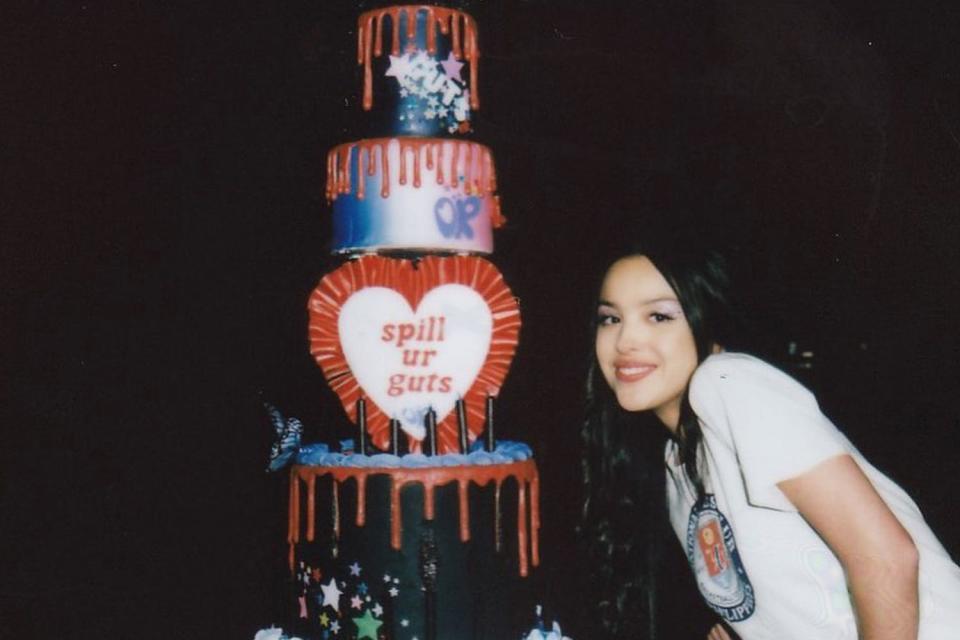 <p>Olivia Rodrigo/Instagram</p> Olivia Rodrigo with her "spill ur guts" 21st birthday cake.