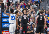 Gonzaga center Chet Holmgren (34) reacts after being called for fouling UCLA guard Peyton Watson (23) during the second half of an NCAA college basketball game on Tuesday, Nov. 23, 2021, in Las Vegas. (AP Photo/L.E. Baskow)