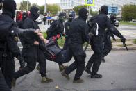 Police detain a demonstrator during an opposition rally to protest the official presidential election results in Minsk, Belarus, Sunday, Sept. 27, 2020.Hundreds of thousands of Belarusians have been protesting daily since the Aug. 9 presidential election. (AP Photo/TUT.by)