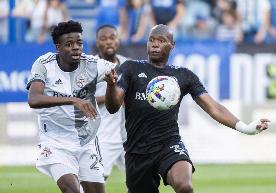 CF Montreal's Kamal Miller, right, is defended by Toronto FC's Deandre Kerr during the first half of an MLS soccer match Saturday, July 16, 2022, in Montreal. (Graham Hughes/The Canadian Press via AP)