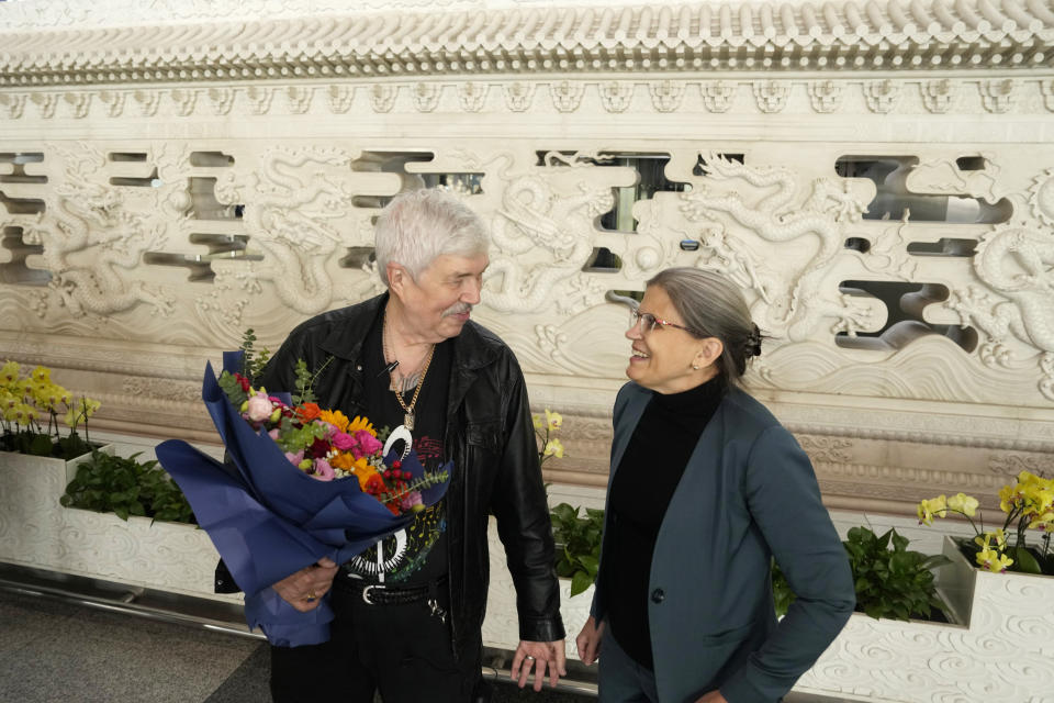 Philadelphia Orchestra's 73-year-old violinist Davyd Booth, left, stands next to Shari Bistransky, Counselor for Public Affairs of the United States Embassy to China, at the Beijing Capital International Airport on Tuesday, Nov. 7, 2023. Musicians from the Philadelphia Orchestra arrived in Beijing on Tuesday, launching a tour commemorating its historic performance in China half a century ago in signs of improving bilateral ties ahead of a highly anticipated meeting between President Joe Biden and Xi Jinping. (AP Photo/Ng Han Guan)